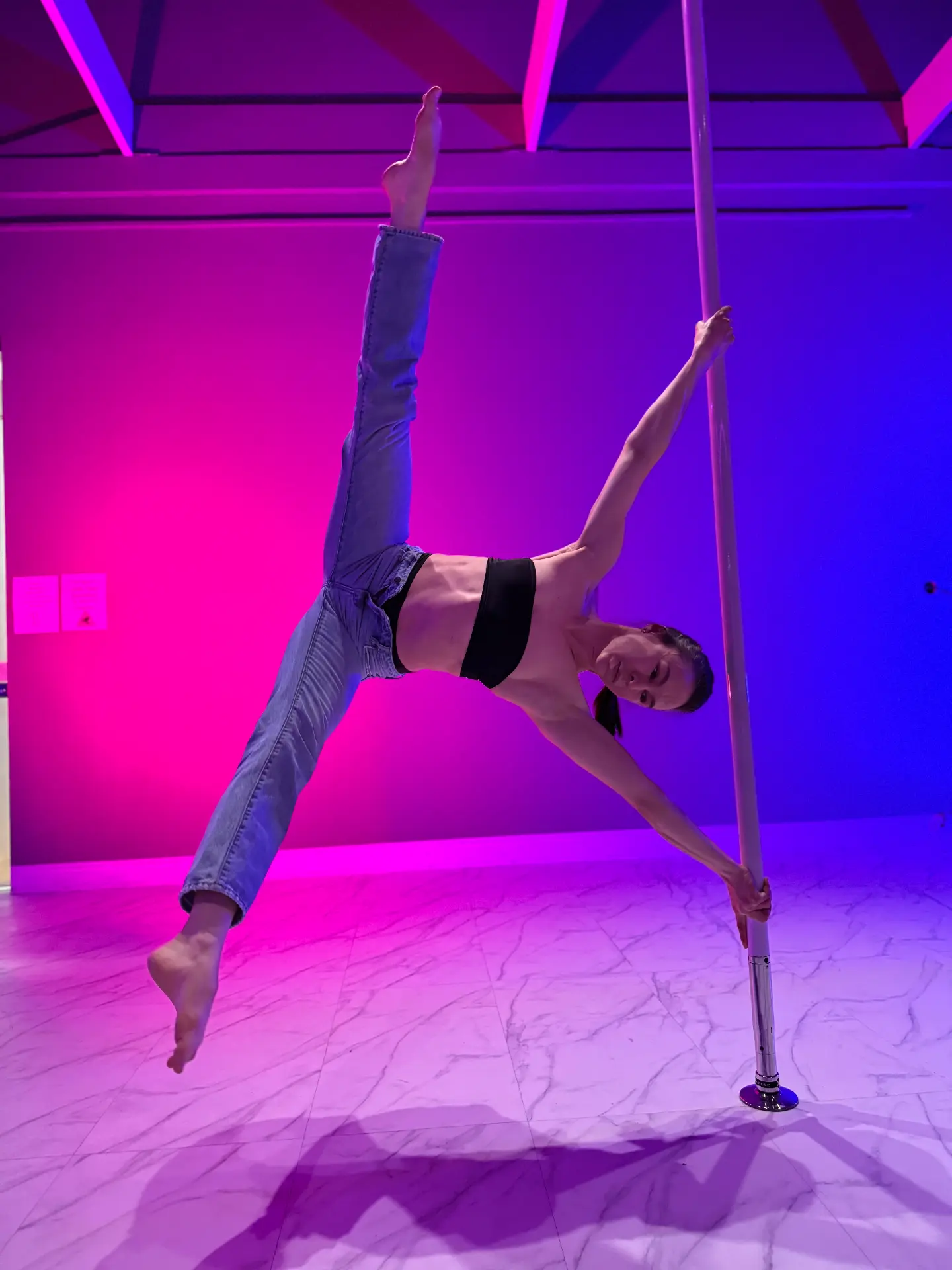 Ira demonstrating a pole move during a live session