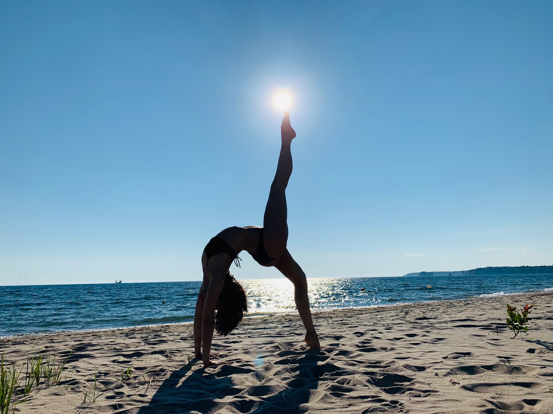 Ira in a one-leg backbend on the beach